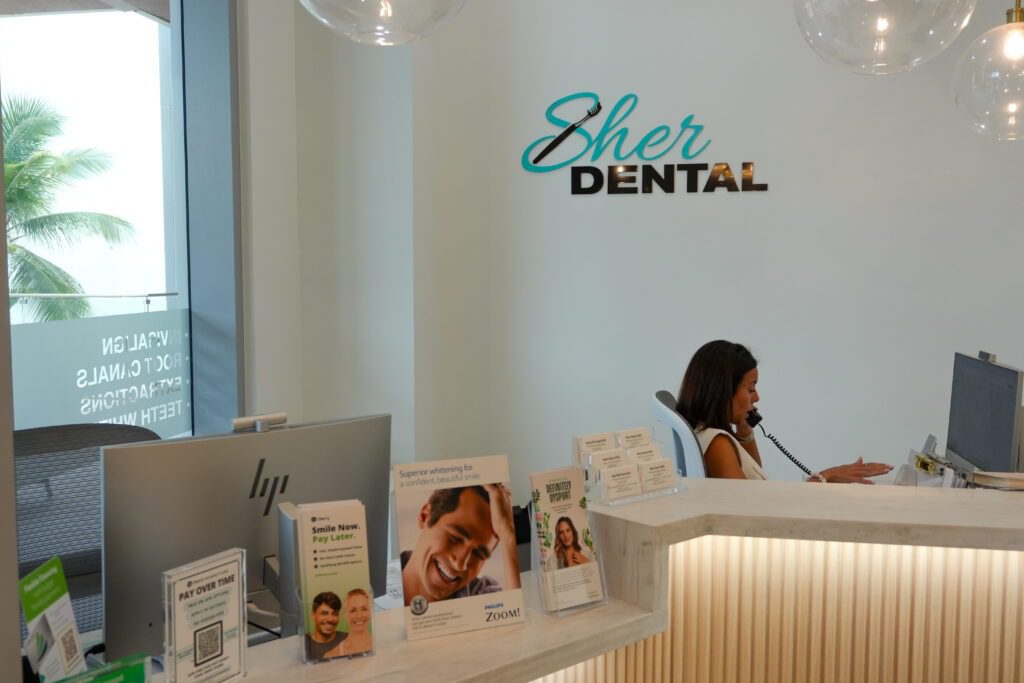 Patient discussing dental financing options at Sher Dental reception