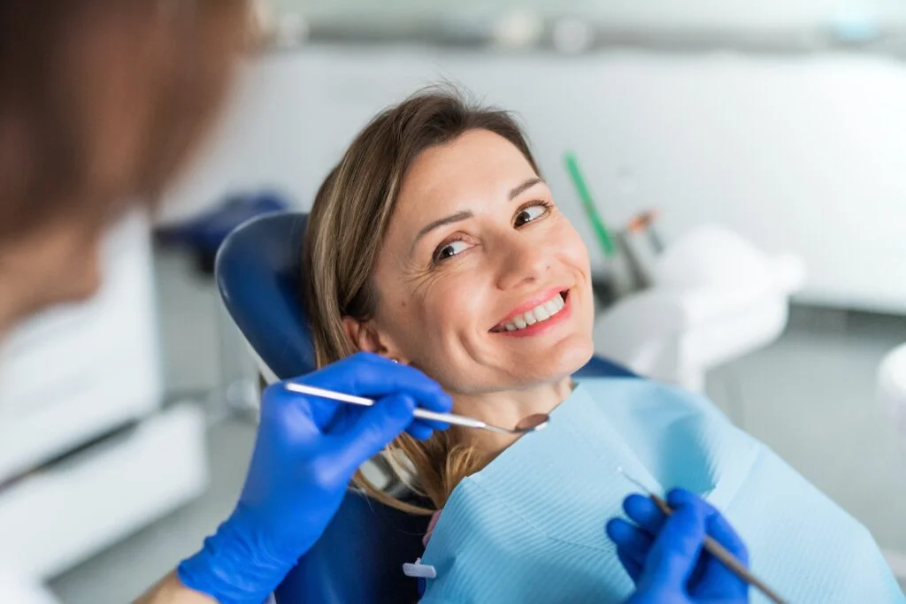 Patient smiling in the chair during treatment at Sher Dental